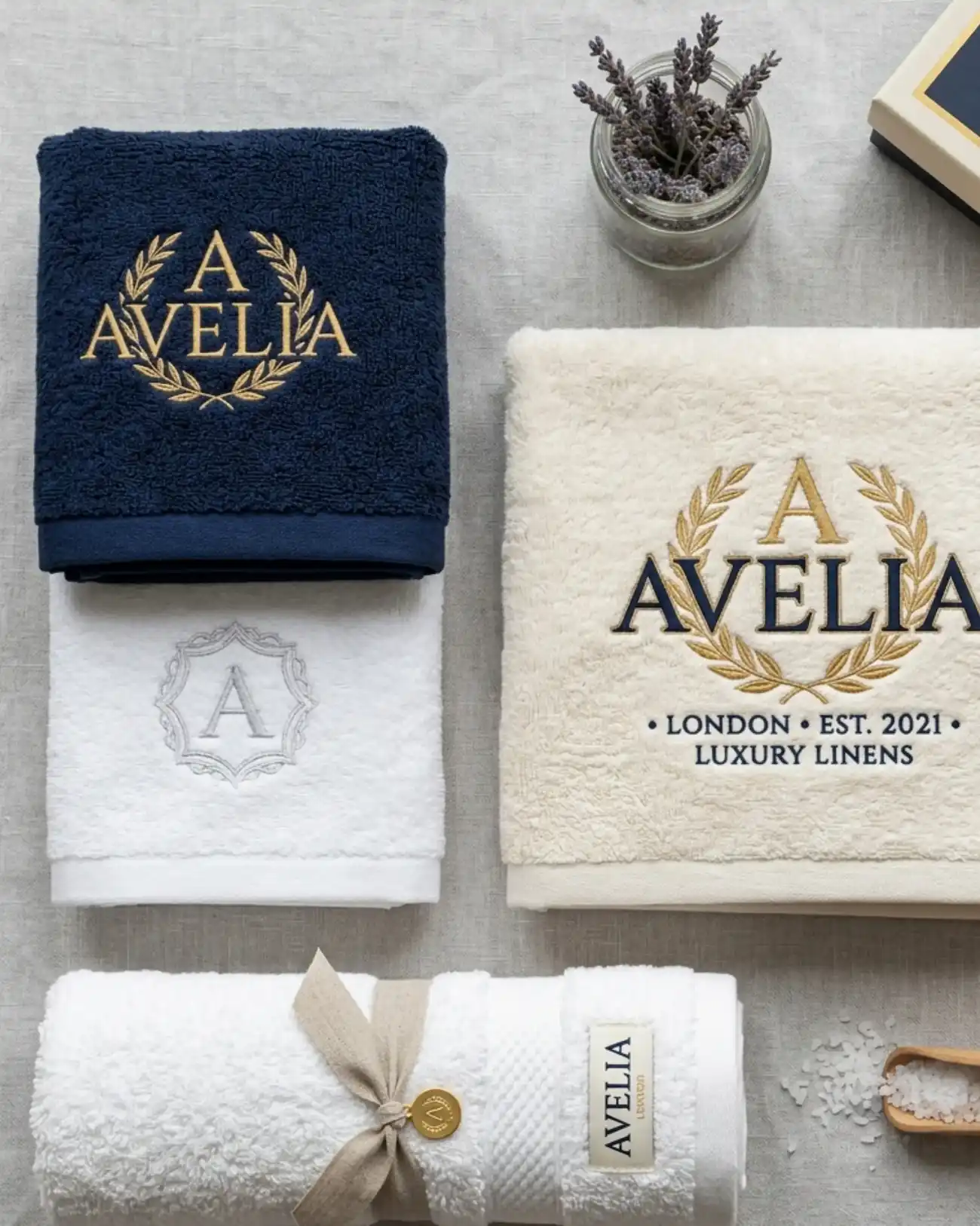 Custom embroidered hotel towels in white and navy blue with personalized logo embroidery for luxury hotels