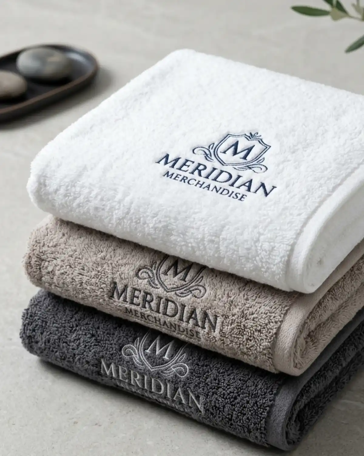 Custom logo embroidered towels in white, taupe and charcoal gray