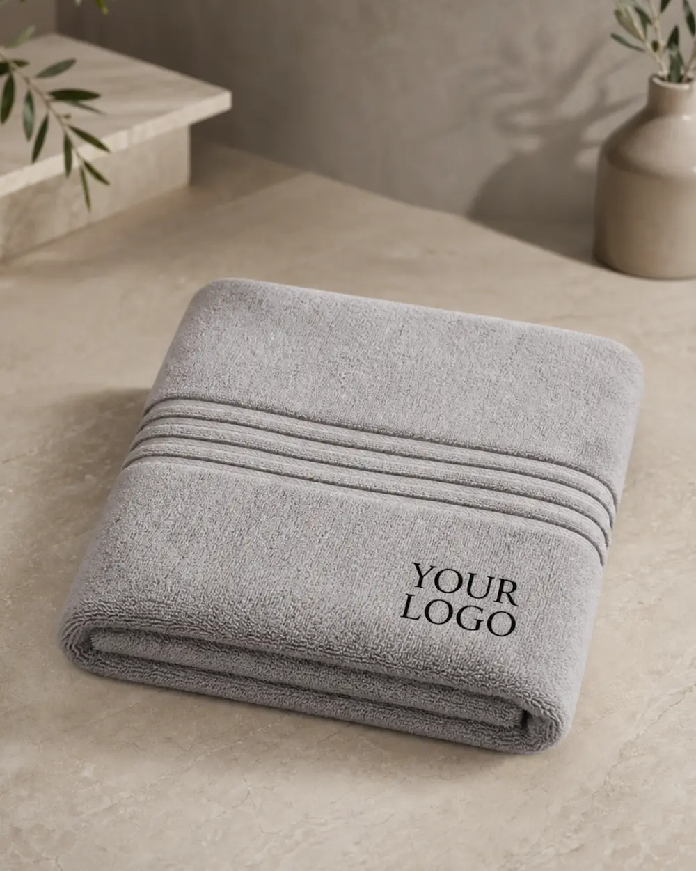 Light grey embroidered promotional towel with custom logo, suitable for corporate gifting and wholesale supply.